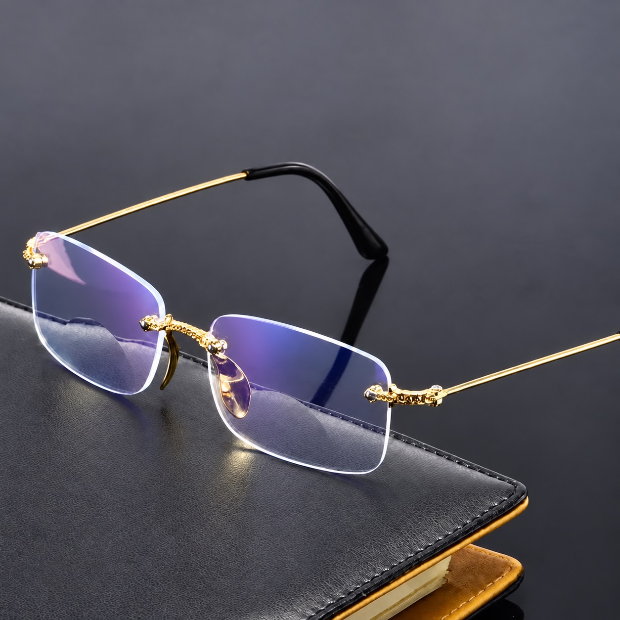 Clearline rimless glasses with an ornate gold bridge, slim gold arms and black ear tips